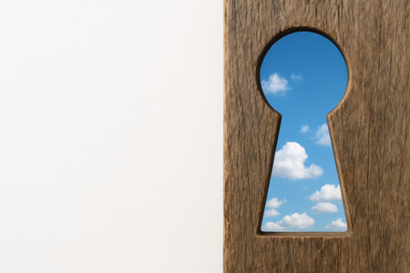 Blue sky with clouds in a keyhole in a tree. Space for textの素材