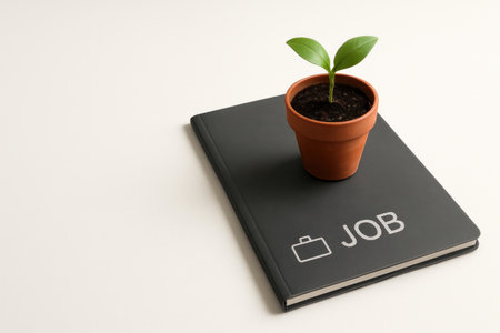 Workbook with a sprout in a pot. Space for textの素材