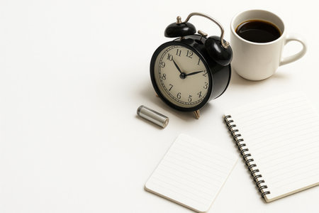 Alarm clock, coffee, notepads and battery. Space for textの素材