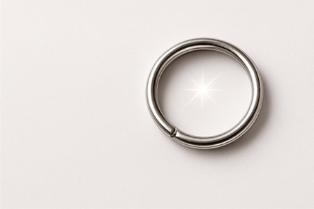 A metal ring with a shiny reflection on a white background. Space for textの素材