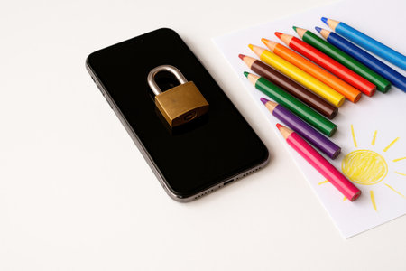 Smartphone with lock and colored pencils for children's drawingの素材