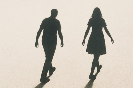 Shadows of a walking man and a woman on a light background. Space for textの素材