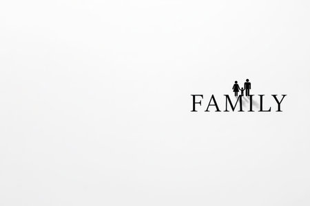 FAMILY lettering with the silhouette of a family holding hands. Space for textの素材