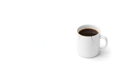 Crackling mug with coffee on a white background. Space for textの素材