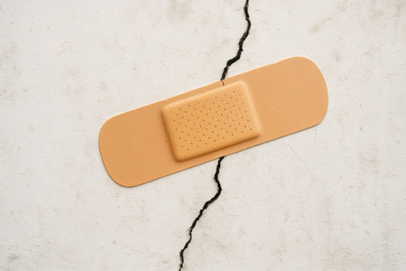 The plaster closes the crack on the light wall. Space for textの素材