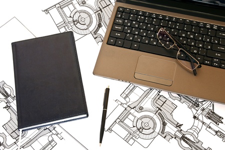 diary lies near the laptop with glasses and a penの写真素材