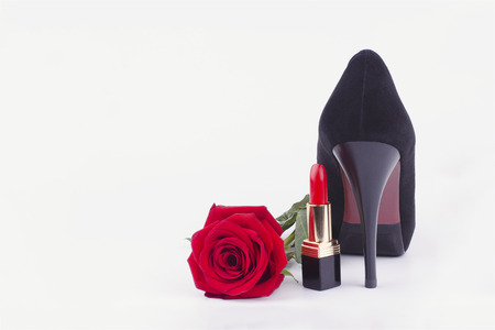 women's heel, lipstick and a rose on a white backgroundの写真素材
