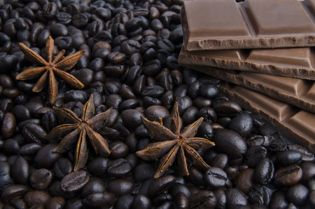 background of black coffee decorated with chocolate and spices