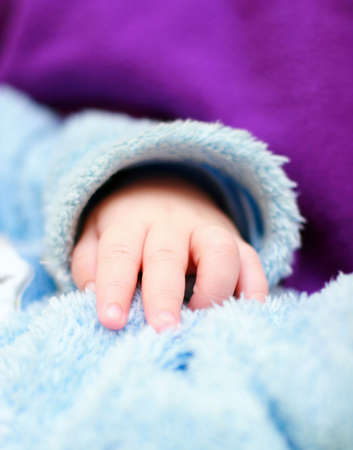 Baby's hand on the fur clothesの写真素材