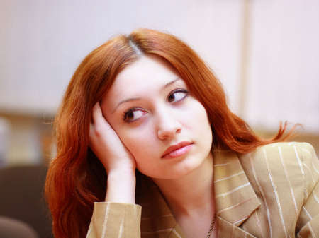 Portrait of girl with reddish hair in office #2の写真素材