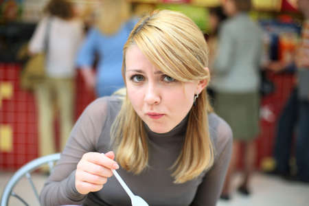 Eating girl with spoon in fast food restaurant #1の写真素材