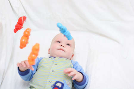 Baby playing with toys. Little boy touching the toys by fingerの写真素材