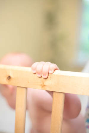 Baby hold bed grating by handの写真素材
