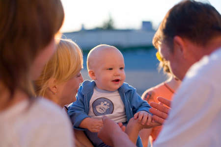 Four adults care about babyの写真素材