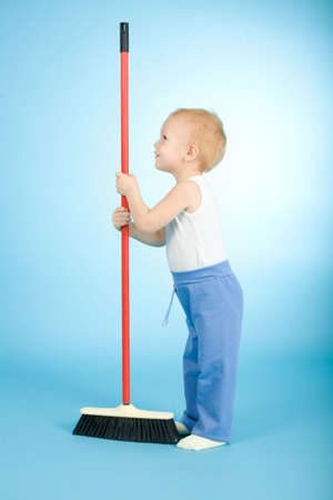 Joyful boy with cleaning swab on blue backgroundの写真素材