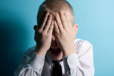 Screaming scared teenager close your face by handsの写真素材