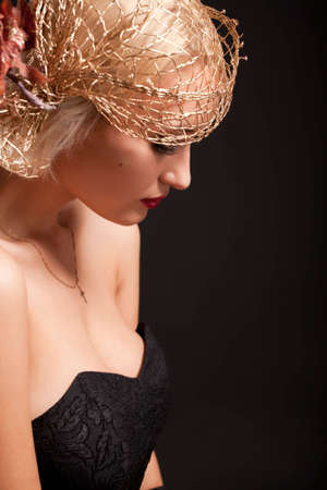 Portrait of attractive retro-style woman in bonnet over black