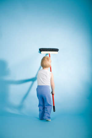 Joyful boy with cleaning swab on blue backgroundの写真素材