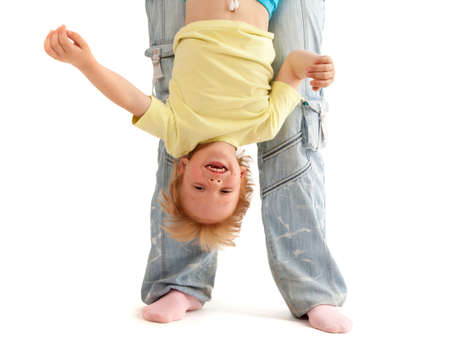 Mother hold her smiling son upside down. Isolated on white