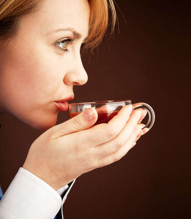 Five-o'clock tea. White collar woman relaxing with hot teaの写真素材