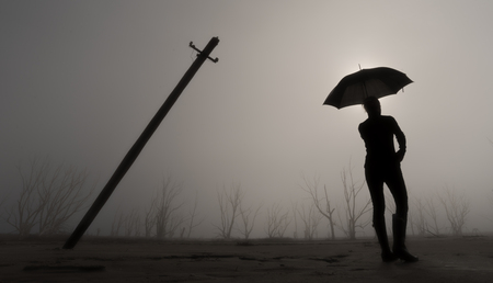 Woman silhouette with umbrellaの写真素材