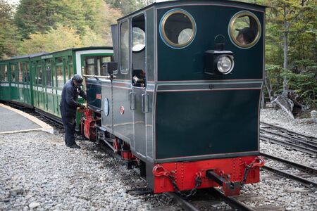 Ushuaia, Argentina - March 28 2019:  The train drivers preparing the locomotive to make the tourist journey within the national park. This train was used by the prisoners to transport firewood until 1947のeditorial素材