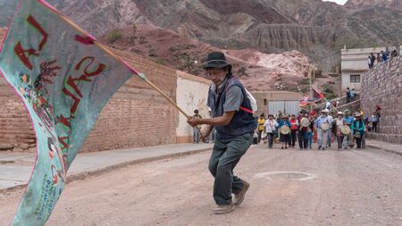 Purmamarca, Argentina - March 5 2017: Group of local people on the streets walking and singing because of the last day of carnival on the high plateaux region of South America.のeditorial素材