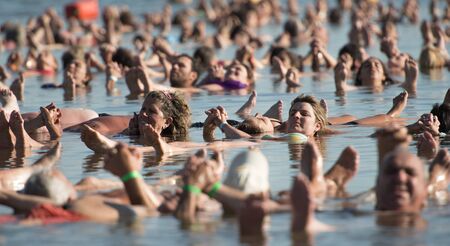 Buenos Aires, Argentina - January 29 2017: Inhabitants of the city of CarhuÃ©, peoplo floating trying to achieve a new world record Guinness, and they did it. This record was possible thanks to the salinity of the lake, similar to the Dead Sea.のeditorial素材