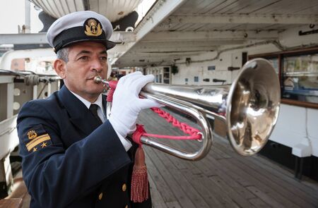 Buenos Aires, Argentina - June 01 2012: An officer of the Argentine Navy playing the trumpet on the frigate Sarmiento located on the dock of Puerto Madero, Buenos Aires Cityのeditorial素材