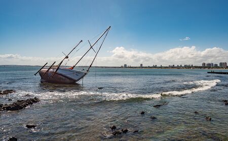Punta del este, Uruguay - March 04 2016: A sailboat on the coast of Punta de Este in front of the center of the city.のeditorial素材