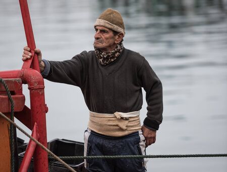 Mar del Plata, Argentina - September 19 2016: It is a small fishing boat, typical of the port of Mar del Plata, returning from a day of fishing, usually depart at dawn and return at sunset. He is a very experienced sailor.のeditorial素材