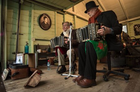 Buenos Aires, Argentina - July 31 2016: Two musicians playing the bandoneÃ³n on the stage inside a house of La Boca.のeditorial素材