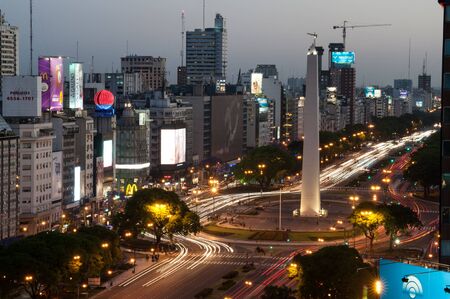 Buenos Aires, Argentina - November 14 2012: Rush hour and traffic on the sreets of Buenos Aires city by night. This photo shows the downtown and de 9 de Julio Avenue arround the obelisc.のeditorial素材