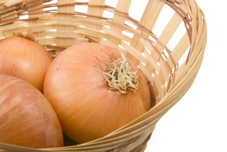 There are same onions in the basket on the white backgroundの写真素材
