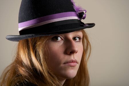 Redhead in blue hat looking sadの写真素材