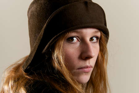Redhead in brown cloche hat looking seriousの写真素材