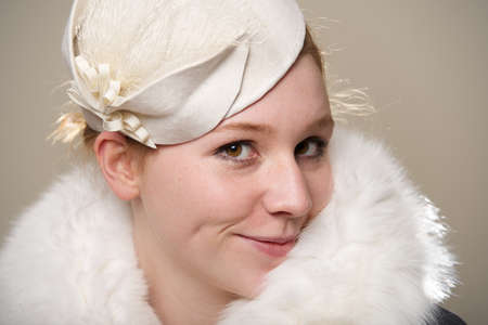 Redhead smiling cheekily in white felt hat and furの写真素材