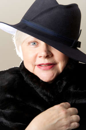 Close-up of white-haired woman in black hatの写真素材