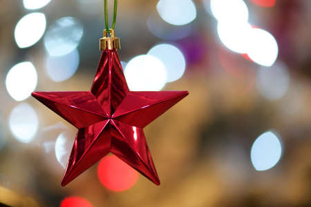Red star with bokeh Xmas tree lightsの写真素材