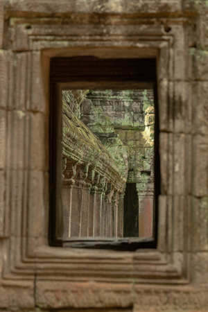 Ruined temple colonnade seen through stone windowの写真素材