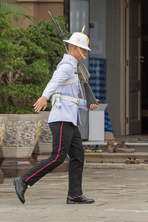 White-jacketed Grand Palace guard running through courtyardのeditorial素材