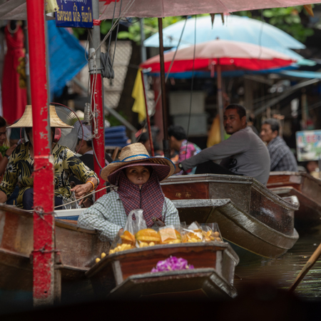Woman with two hats in floating marketのeditorial素材