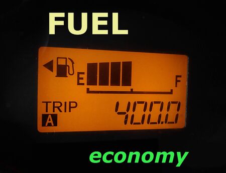Fuel economy: fuel gauge and odometer showing a minimum fuel consumptionの写真素材