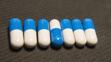 same medications and tablets on a wooden texture table