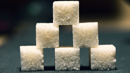 Pyramid of six sugar cubes, low light backgroundの写真素材