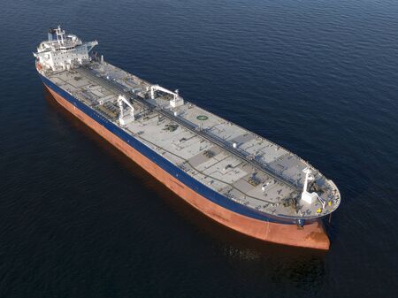 Oil Tanker in the Baltic Sea off at anchor, calm weather, drone shot