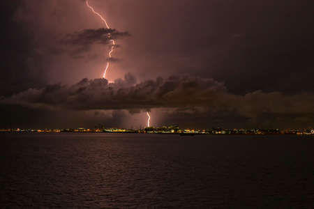 lightning strikes through the cloud into the chimney of the factory, Singapore 2020の写真素材