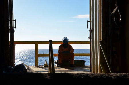 A construction crew rests at starboard side of the pipe lay barge during break.