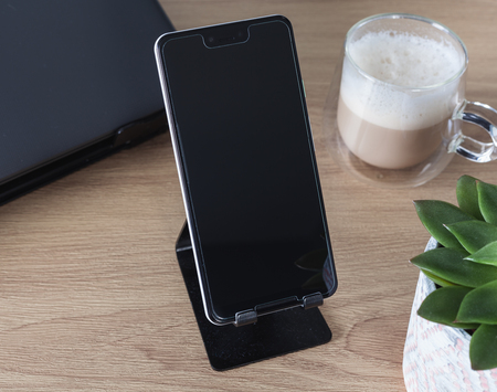Google Pixel 3 XL sits on phone holder on deskのeditorial素材