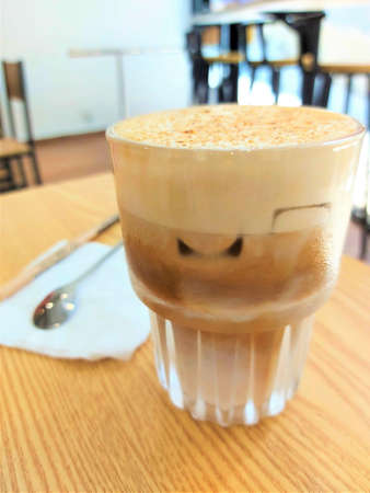 iced latte coffee on a wood tableの写真素材